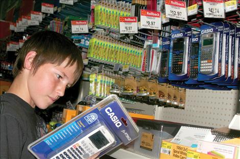 Dylan Wilson looks for the calculator he needs to start 8th grade this fall school year in Ronan.
