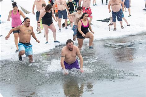 New Year’s Day revelers charge into the icy waters of Flathead Lake in celebration of the new year.