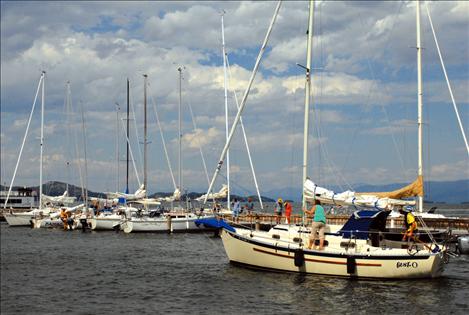 A sailboat pulls in to join other members of the North Flathead Yacht Club in their "voyage to the end of the world."