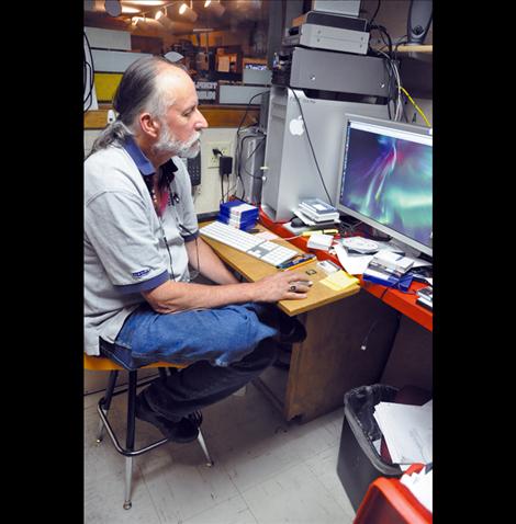 Surrounded by audio and editing equipment, Frank Tyro spends hours programming for Salish Kootenai College’s public television station KSKC. 