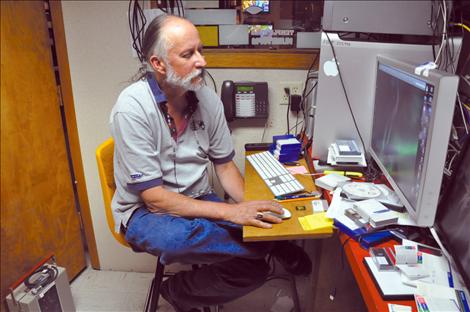 Surrounded by audio and editing equipment, Frank Tyro spends hours programming for Salish Kootenai College’s public television station KSKC.