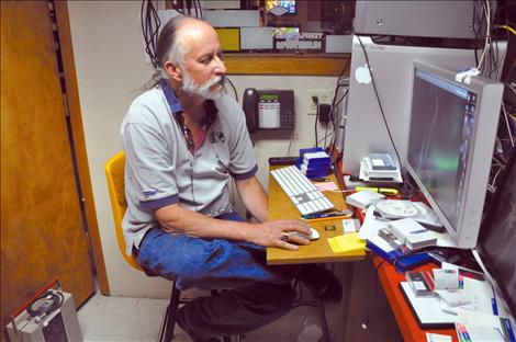 Surrounded by audio and editing equipment, Frank Tyro spends hours programming for Salish Kootenai College’s public television station KSKC. 