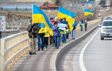 Drivers passing by honked and waved as area residents marched across the Polson bridge in support of Ukraine.