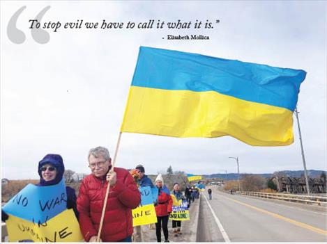 As the invasion of Ukraine by Russian forces intensified last week, concerned citizens marched with Ukrainian flags across the Armed Forces Memorial Bridge in Polson to show support for the democratic country.