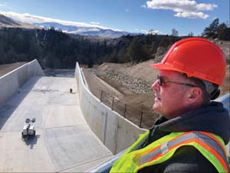 Safety of Dams coordinator Gregory Wilson looks over the completed spillway at Crow Dam, west of Ronan. The road over the dam is slated to reopen April 1 after a two-year closure. 