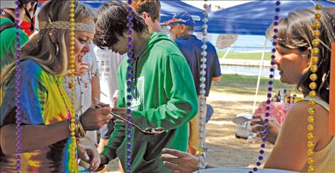 Allyn Cass ladles Psychedelic Chili for a taster at the Payne West Insurance booth at Rotary’s Festival for Youth.