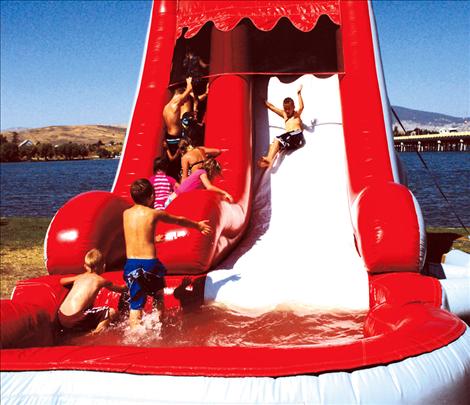 Youngsters enjoy the water slide, a cool place to play while Mom and Dad tried some chili.