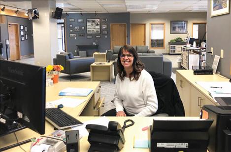 Banker Laura Burland helps customers from her work station in the spacious lobby of Valley Bank’s Polson branch. 