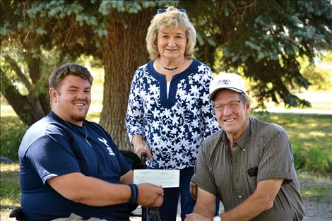 Marine veteran Tomy Parker, left, presents a $300 donation to Magazines for Troops, represented by volunteers Esther and Gene Gunlock. The contribution was provided by Battle for Veterans, a California-based group for which Parker provided public relations services. 