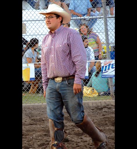 Pete White heads towards the calf chutes at the Polson fairgrounds. White wears his shin guards, made of heavy leather, which protect his lower legs when he’s picking up bucking horses.