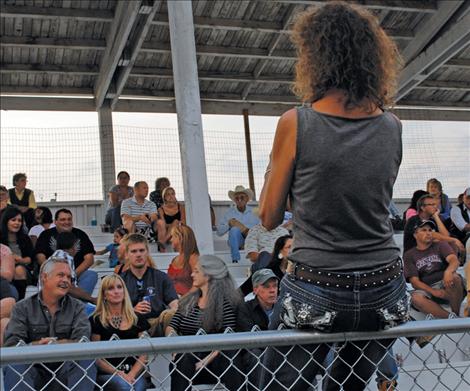 A spectator snaps a photo during the rodeo.