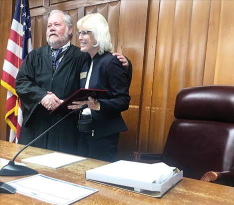 Justice Ingrid Gustafson gives retiring District Court Judge Jim Manley a plaque from the Montana Supreme Court in honor of his many years of service, both as a judge and as an attorney. 