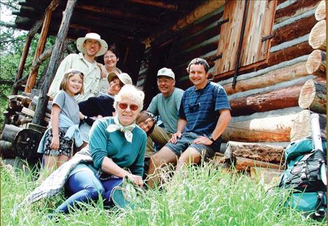 Members of the McClure family (that’s Dayna in the foreground and Craig behind, to the right) during a visit to Yellowstone Park’s Lower Blacktail Patrol Cabin, demolished by flooding June 13.
