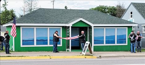 Members of the Raven Hall Motorcycle Club retire an old U.S. flag and replace it with a new one at Flathead Lake Herb. Club members provided the same service to many other busineses and individuals in Polson prior to the 4th of July holiday.