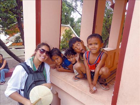 Camaleigh Old Coyote poses with Cambodian children.
