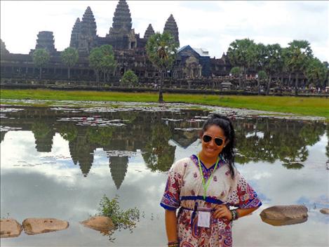 Camaleigh Old Coyote stands in front of a temple in Cambodia.