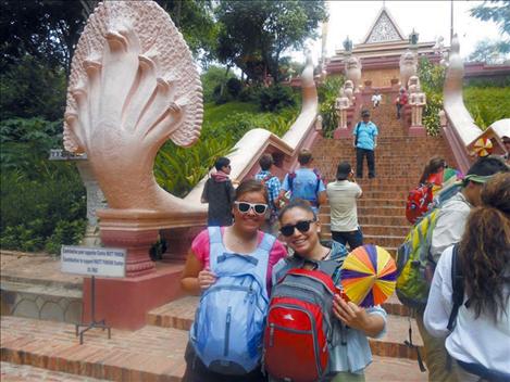 Courtney Perry, left, and Nichole Rang, right, pause for a photograph in front of a temple in Cambodia. 