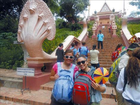 Courtney Perry, left, and Nichole Rang, right, pause for a photograph in front of a temple in Cambodia.