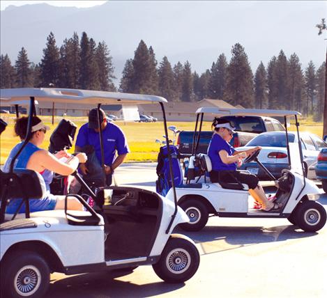 Susie’s teams pull out of the parking lot at the Silver Fox Golf Course.