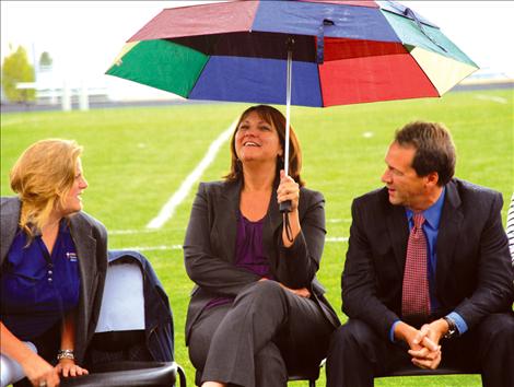  Dr. Kelly Bagnell, left, Superintendent of Public Instruction Denise Juneau and Governor Steve Bullock brave  the rain at  the Graduation Matters Kickoff at  Polson High School. 