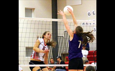 Alexis Shick of Arlee has her kill blocked by Charlo’s Aspen Runkel, on of three blocks in the game for Runkel. She also led with three aces, 19 digs and eight kills. 