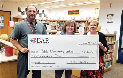 Pablo Elementary School Principal Ryan Fisher, Librarian Gay Speckert and Kuilix Chapter DAR member Sharon Adamson