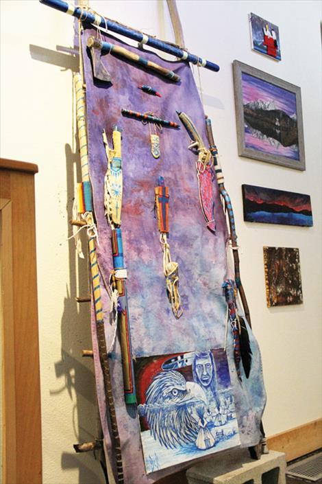 Buck Morigeau’s tipi door is displayed with a blacklight to emphasize the use of color and the chosen materials. 