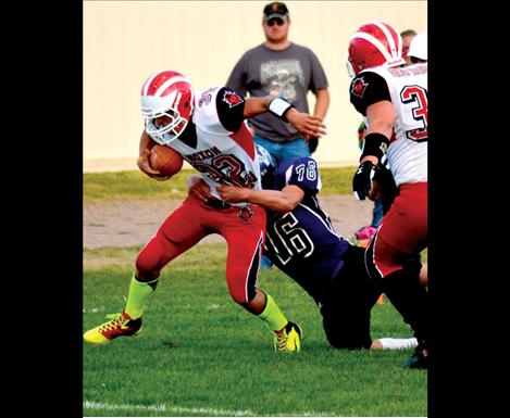 Charlo senior Trinceton Brown tackles Noxon quarterback Bradley Fitchett in the endzone for a safety after the Red Devils fumbled the ball on a punt attempt.
