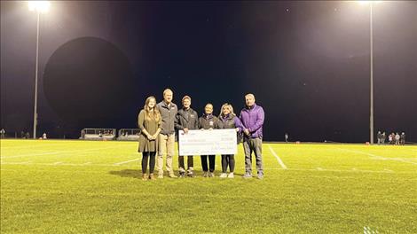 St. Luke Providers, Dr. Kena Lackman, Dr. Tyler Thorson, and Rob Alfiero, PA-C, presented the 2022 sports donation to the Polson Booster Club.