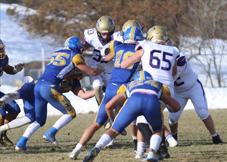 Pirate half back Keyen Nash tries to climb over Fergus defenders in the State semifinal on Saturday.