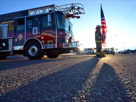 As the sun rose Wednesday, Sept. 11, Polson firefighter Terry Gembala stood at attention along Highway 93 in honor of fallen emergency responders and others killed in the attack on the Twin Towers. Gembala stood for 102 minutes, the time it took for the first tower to fall. At the moment the tower fell in Mountain Time, KC Sorensen played taps and Amazing Grace on his bugle. Throughout the day, firefighters rotated hourly shifts.