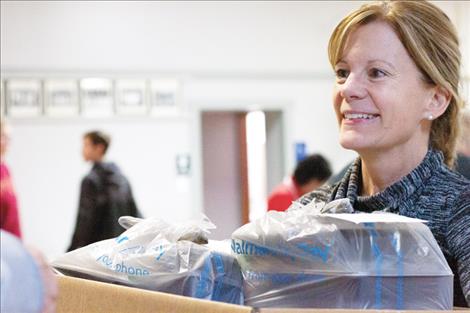 A volunteer at the Polson Community Thanksgiving Dinner prepares to deliver meals to those unable to pick them up.