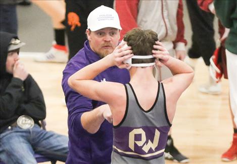 Assistant Coach Cheff coaches Polson wrestler Daniel O’Roake.