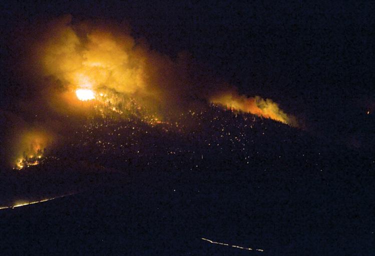 Fire rages up a mountainside in the Irvine Flats area Aug. 14.