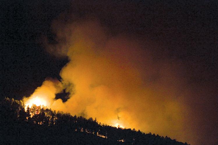 Flames climb a ridge in the Irvine Flats area Aug. 13.