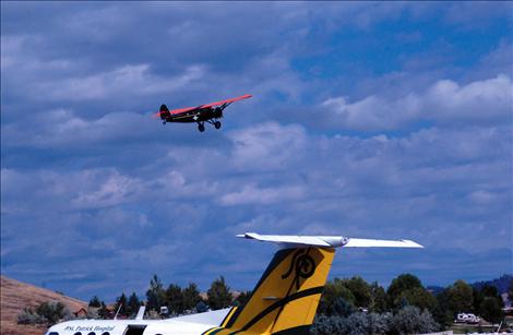 Hank Galpin, 64, Kalispell, pilots his 1928 TravelAir 6000 over Polson Airport during the Polson Fly-In.