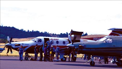 Visitors at the Polson Fly-In look around inside the Alert plane, which specializes in medical flights. 