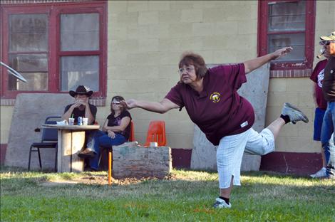 Juanita Johnson ends her horseshoe toss perched on one foot every time. 