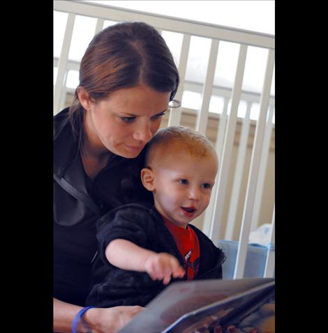 Colter Cross, 2, reads with his mother Bobbie. Colter made a miraculous recovery after complications from open heart surgery performed when he was 11 days old. His family is raising funds for the Missoula Heart Walk to let people know heart disease isn’t only an adult problem.  