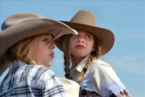 Sisters Coral, left, and Yzabel Mergenthaler rode on the Idle Spur float, fashioned by their grandfather.
