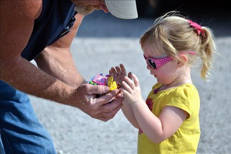 Taryn Veach surveys her load of candy scooped up at the Dayton Daze parade.