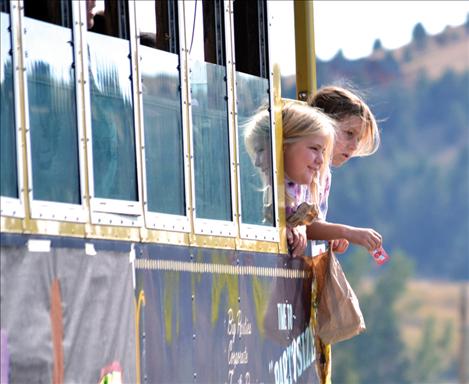 Polson's Three Dog Down trolley held passengers who tossed candy to the kids.