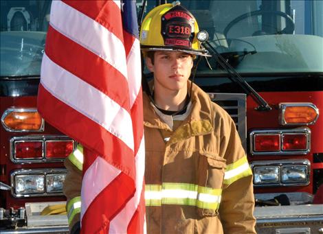 Junior firefighter Taylor Haynes, 16, stands for the fallen of 9/11. He said he remembers the day, “a lttle bit.”