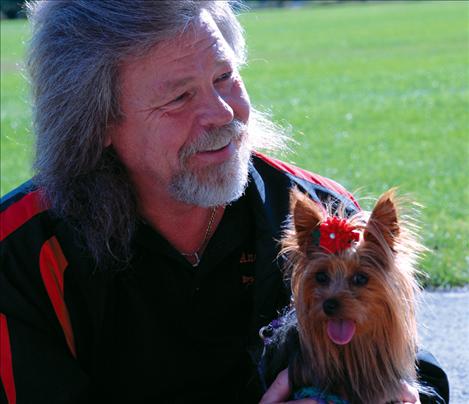 Dennis Anderson holds Sami, one of the Anderson family’s Yorkshire terriers. Sami won worst behaved at the Doggy Dash. 