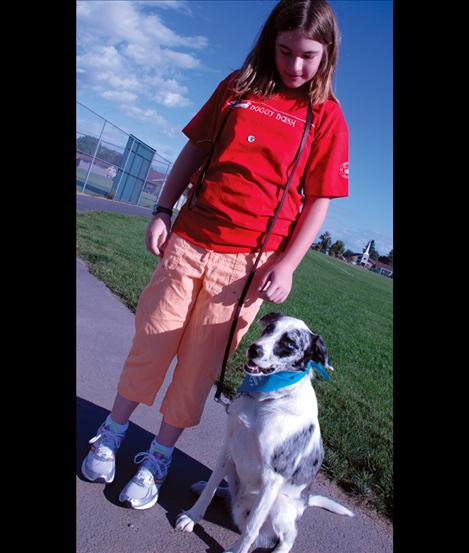 Mesa McKee and her dog, Lego, a border collie walk at the Doggy Dash. 