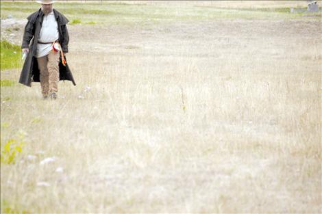 Phil Peck crosses a field in toward the trading post, creating a timeless image.