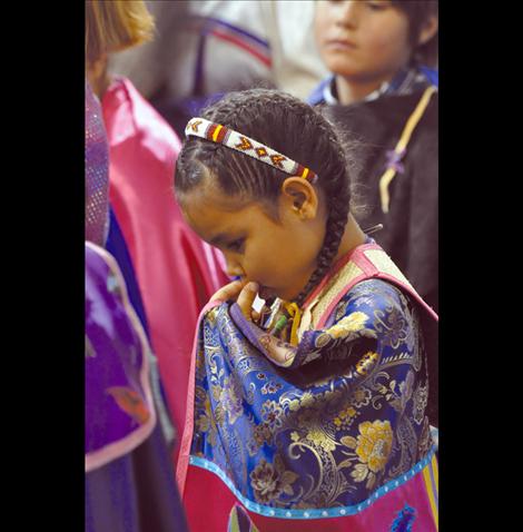 Elannah Flatlip takes a break from dancing at a powwow in St. Ignatius.