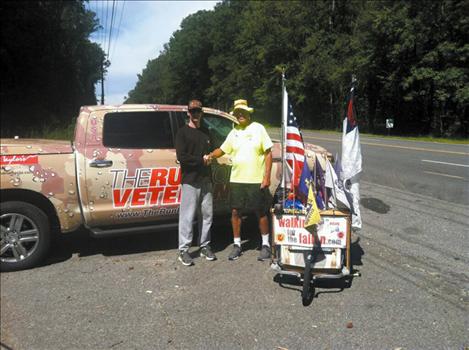 Brendan O’Toole, left, met up with Ronan’s Chuck Lewis in Virginia. Both Marine veterans are crossing the country by foot to help wounded soldiers.