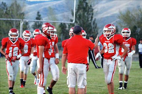 The Arlee Warrior football team gathers around for instruction during their homecoming game against Drummond. Head coach Mike Rogers doesn’t let the inexperience of his young team daunt him, but continually encourages them as they improve.