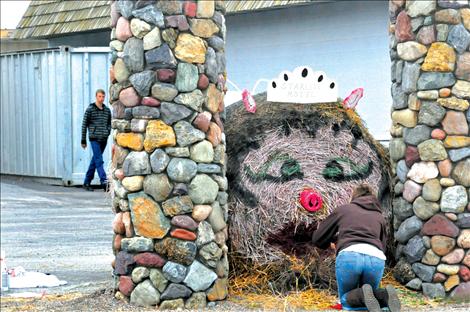 Final details are put on the Starlite Motel’s entry into the Ronan Harvest Festival round bale contest. 